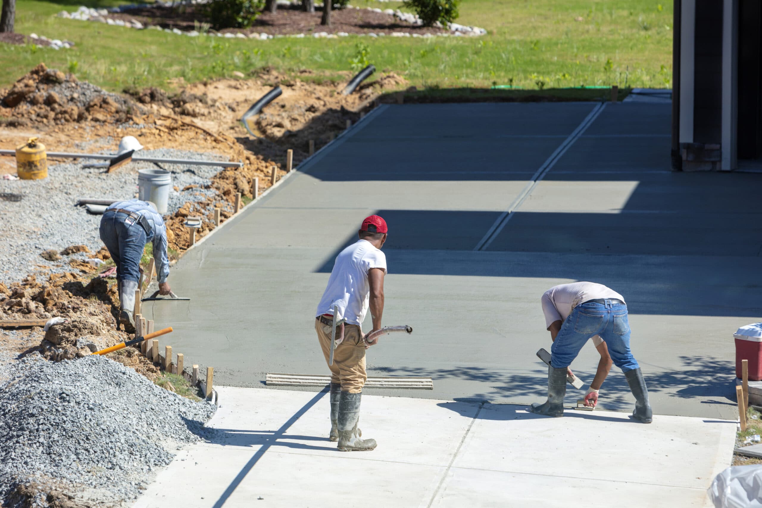 men working on a new concrete driveway